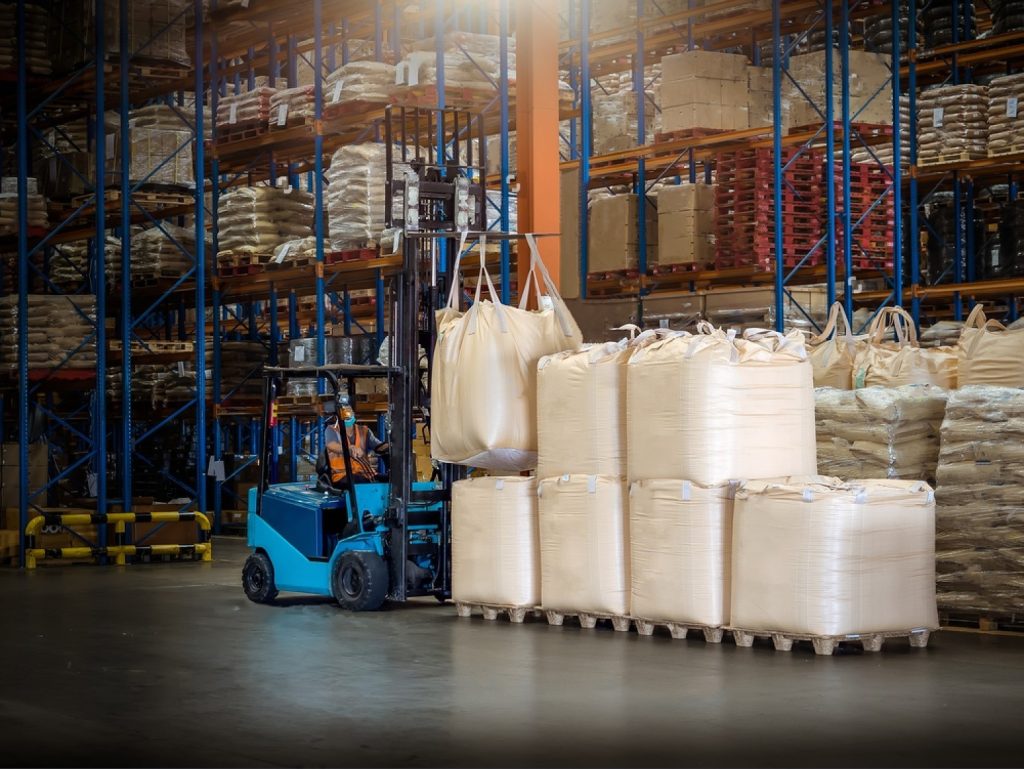 stock-photo-forklift-is-handling-jumbo-bags-in-large-warehouse-714623605-transformed